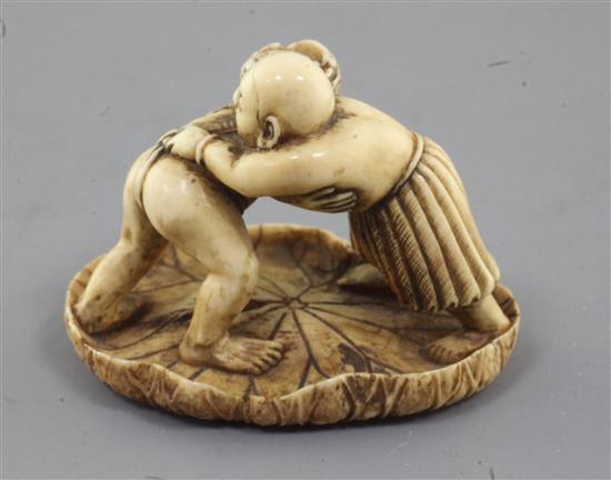 A Japanese ivory netsuke of two wrestlers, Meiji period, w. 4.2cm